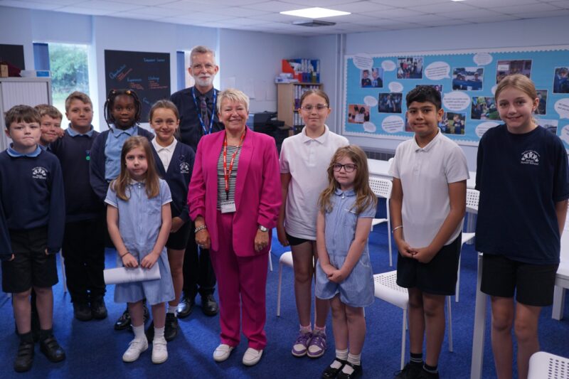 Rachel with students and Headteacher Mr. Mann at Exhall Junior School. 