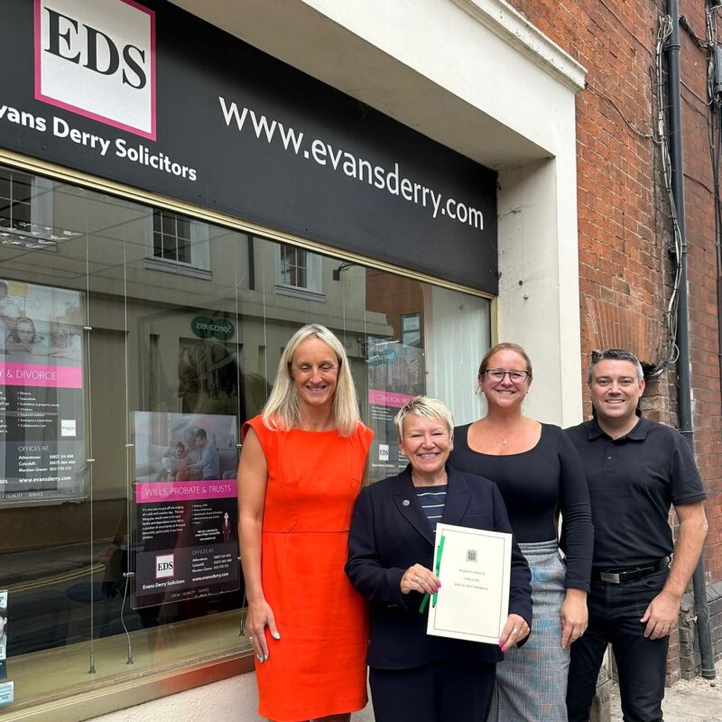 Rachel presenting a signed copy of her maiden speech to Evan Derry Solicitors