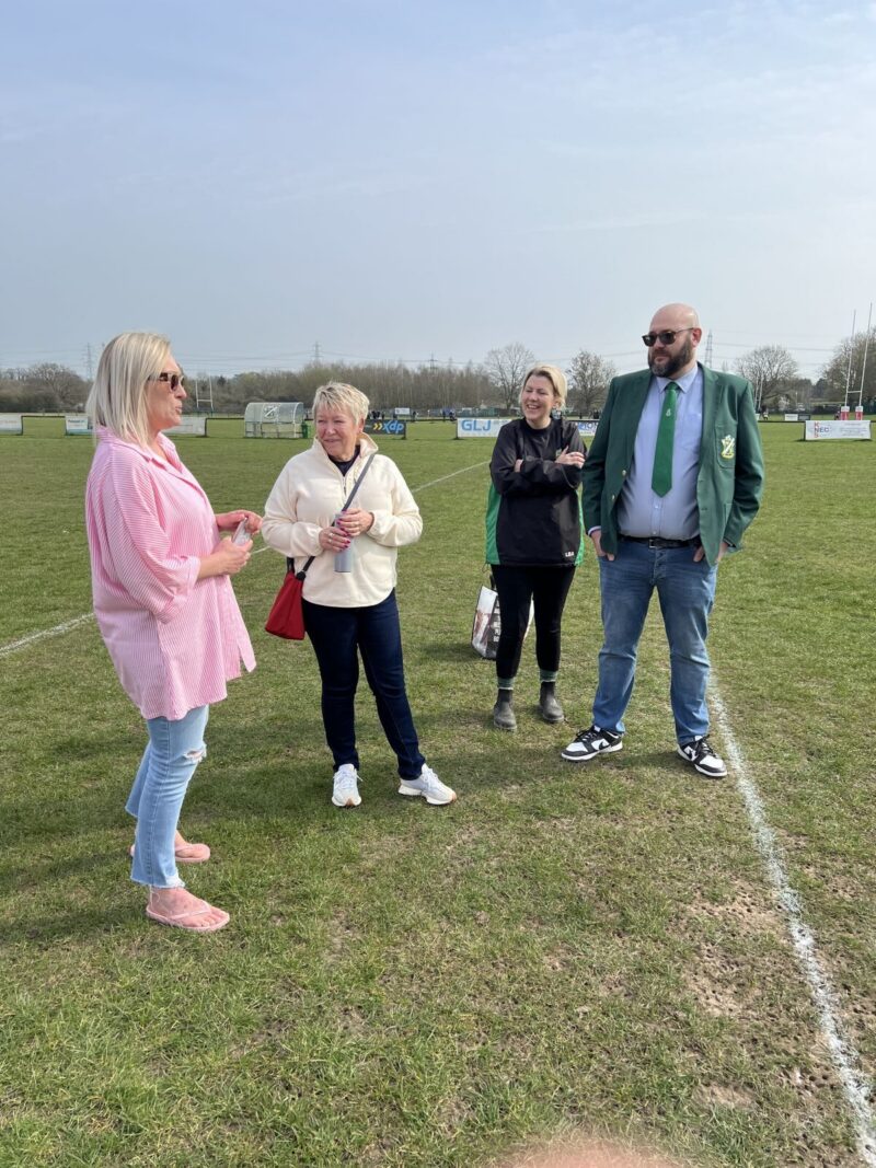 Rachel Taylor on a pitch with volunteers form a local Rugby club.